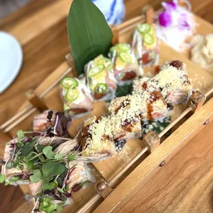 albacore roll (L), kaizen roll (top), salmon aburi roll (top)