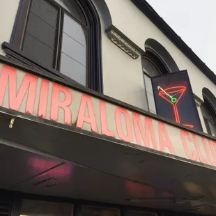 a neon sign on the side of a building
