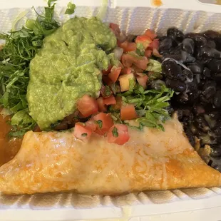 Carnitas enchilada ala carte $9 with Blk beans, salsa, greens  and guacamole.  It's filling but not so tasty.