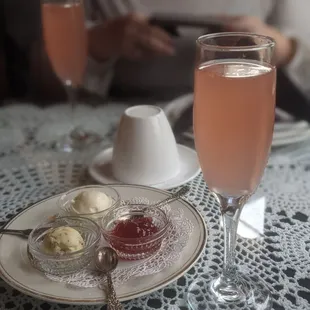 a glass of champagne and a plate of scones