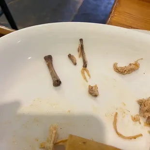 Chicken bones in a child&apos;s plate.