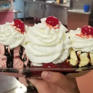 a hand holding a sundae