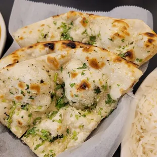 a plate of rice and naan bread