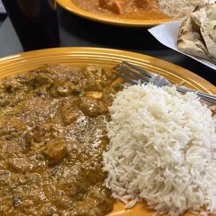 Fish Saag front.  Chicken curry and garlic naan in the background.