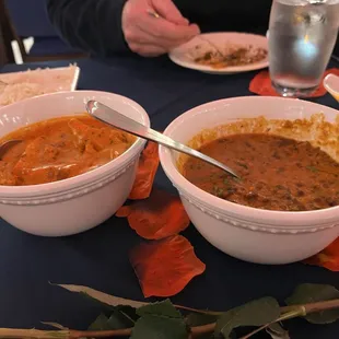 Butter chicken left, black dal right, and husband eating his dinner on the appetizer plate.