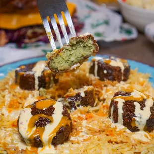 Need a vegetarian option? We got the perfect dish for you! Try our Grilled or Fried chickpea falafel patties over a bed of rice.