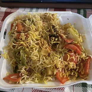 a plate of food with a laptop in the background