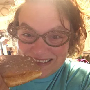 a woman eating a doughnut
