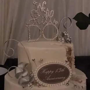 a white wedding cake with silver decorations