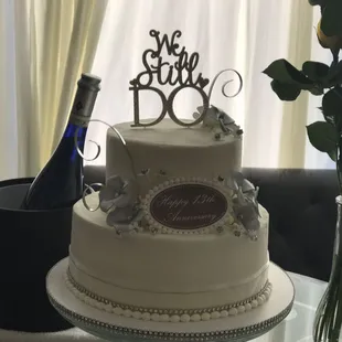 a wedding cake with a bottle of champagne