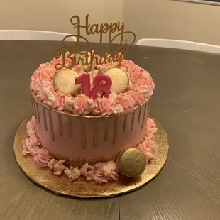 a pink and gold birthday cake
