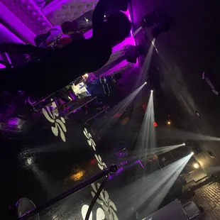 a view of a stage with lights and a dj