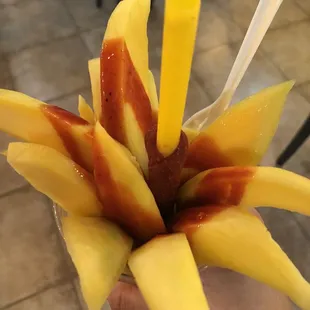 a close up of a person&apos;s hand holding a piece of fruit