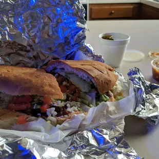 Torta Al pastor with pickled jalapeno and salsa on side.