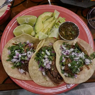 a plate of tacos and salsa