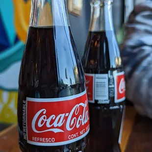 a bottle of coca cola and a donut