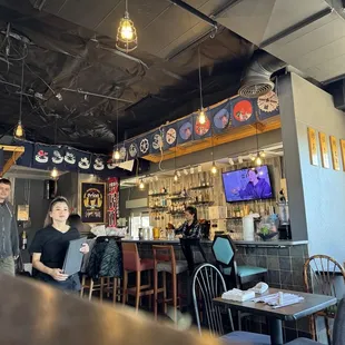 two people standing in a restaurant