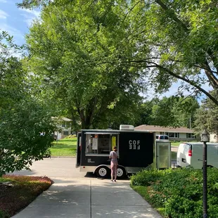 a woman standing in front of a food truck