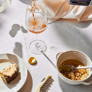 a person pouring wine into a glass