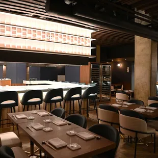 a dining room with a bar and chairs