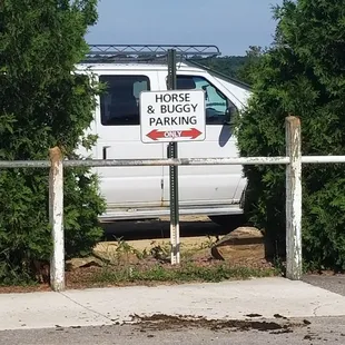 a white van parked behind a fence