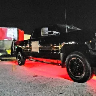 a black truck with red lights