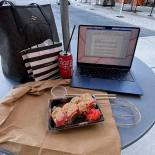 a laptop and a lunch on a table