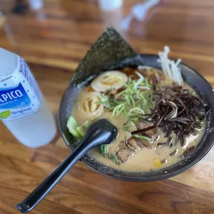 a bowl of ramen and a bottle of water