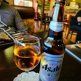 a glass of wine and a bottle of beer