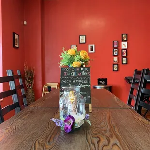 a wooden table with a chalkboard sign on it