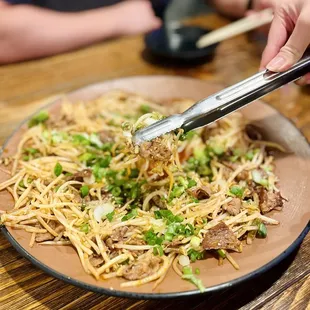 Stir fried beef brisket and mung bean sprouts