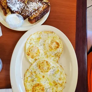 two plates of breakfast food
