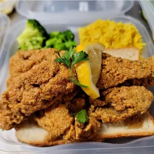 a meal of fried chicken, rice and broccoli