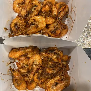 two boxes of cooked shrimp