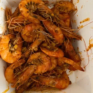 a white container filled with cooked shrimp