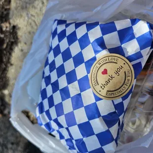 a blue and white checkered bag of food