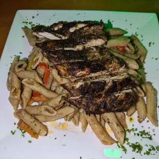 Jerk Chicken Rasta Pasta - Succulent chicken breast grilled in a spicy jerk seasoning alongside their signature pasta blend