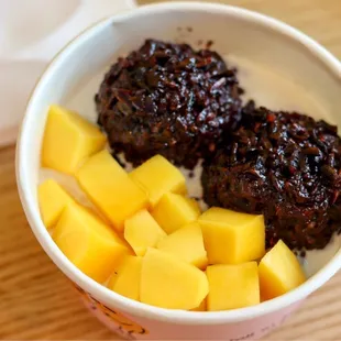 a bowl of fruit and a cup of coffee