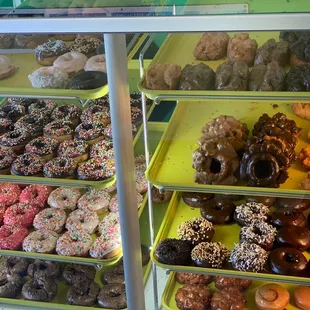 a variety of donuts in a display case