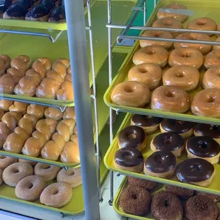 a variety of donuts in a display case