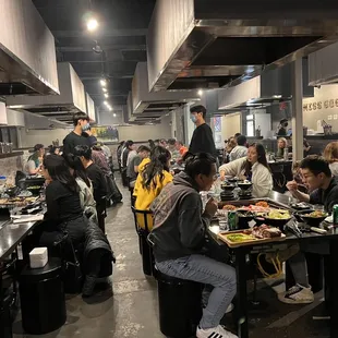 a large group of people eating in a restaurant