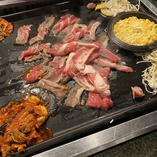 a variety of meats on a grill