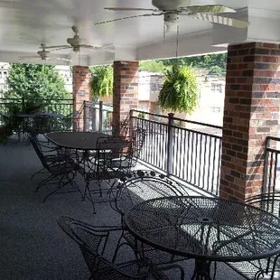 a balcony with tables and chairs
