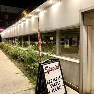 a sign in front of a restaurant