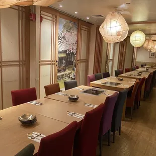 a long dining table with red chairs
