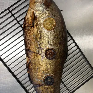 Whole smoked salmon with sliced lemons, honey and ginger. Slow smoked in our pellet smoker. Alder pellets