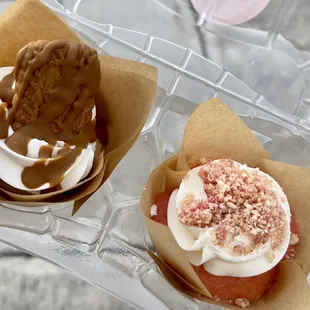 two cupcakes with frosting and toppings