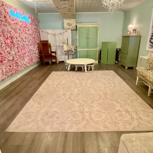 a living room with a floral wall