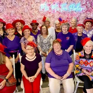 a group of women in red hats