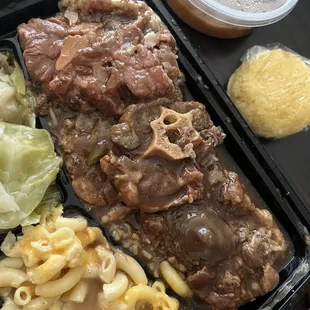 Oxtails with Oven Baked Macaroni and Cheese + Cabbage. Peach Cobbler